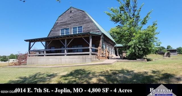back of property featuring a yard
