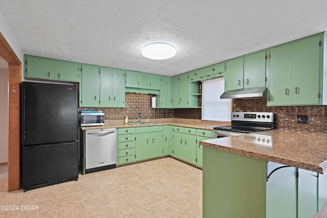 kitchen with a textured ceiling, tasteful backsplash, stainless steel appliances, sink, and green cabinetry