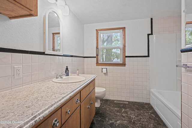 bathroom with backsplash, toilet, tile walls, vanity, and a textured ceiling