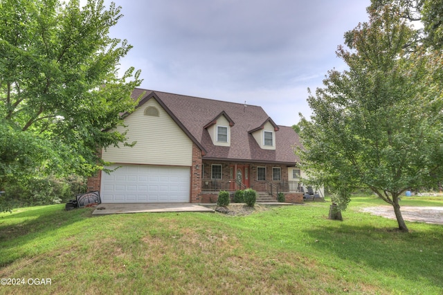 cape cod house featuring a porch, an attached garage, brick siding, driveway, and a front yard