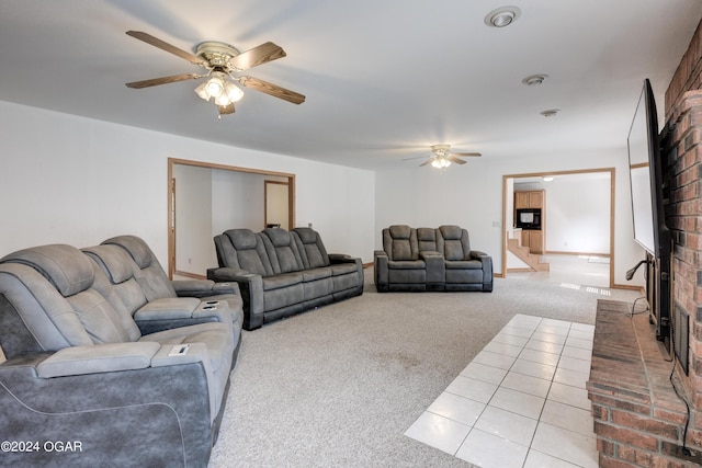 living room with ceiling fan, a fireplace, and carpet flooring