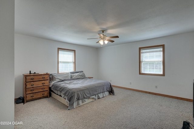 bedroom with baseboards, a ceiling fan, and light colored carpet