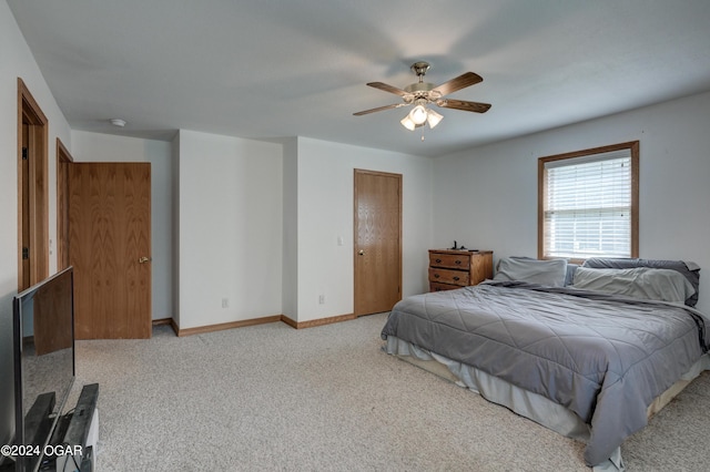 bedroom with carpet, ceiling fan, and baseboards