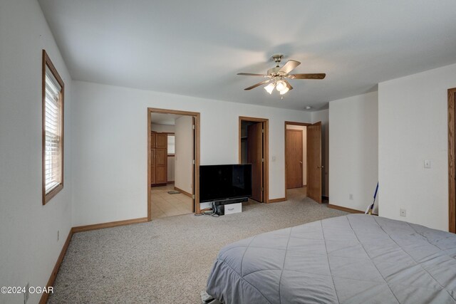 carpeted bedroom featuring baseboards and a ceiling fan