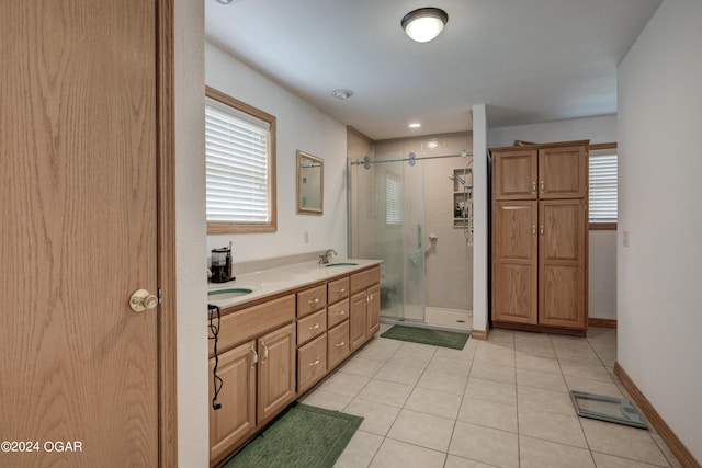 bathroom with double vanity, visible vents, baseboards, tile patterned flooring, and a shower stall