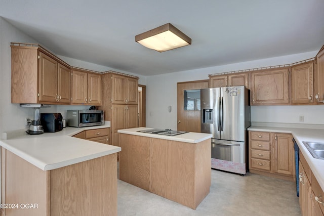 kitchen with a center island, stainless steel appliances, light countertops, a sink, and a peninsula