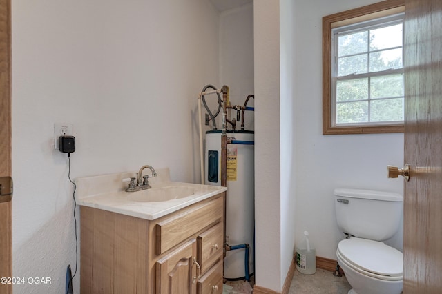 bathroom featuring baseboards, water heater, vanity, and toilet