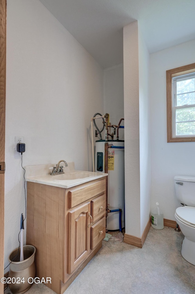 half bath with gas water heater, baseboards, vanity, and toilet