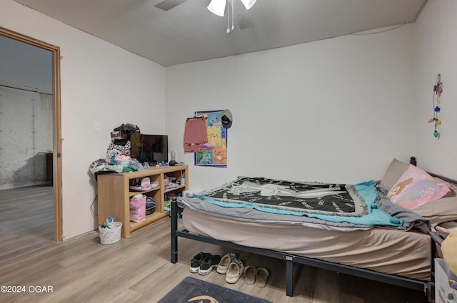 bedroom with ceiling fan and wood finished floors