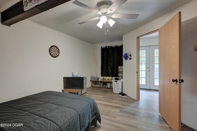 bedroom featuring a ceiling fan, light wood-type flooring, and french doors