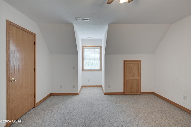 bonus room featuring visible vents, a ceiling fan, light carpet, vaulted ceiling, and baseboards