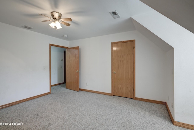 additional living space with baseboards, visible vents, a ceiling fan, and light colored carpet