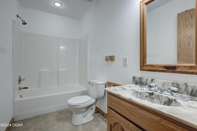 bathroom featuring a textured wall, toilet, vanity, baseboards, and shower / washtub combination