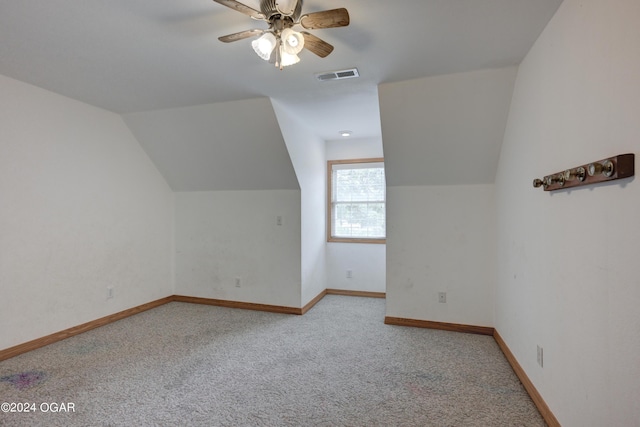 additional living space featuring carpet floors, visible vents, vaulted ceiling, and baseboards