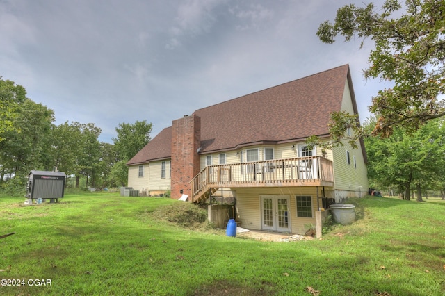 back of house with a deck, a yard, french doors, and a chimney