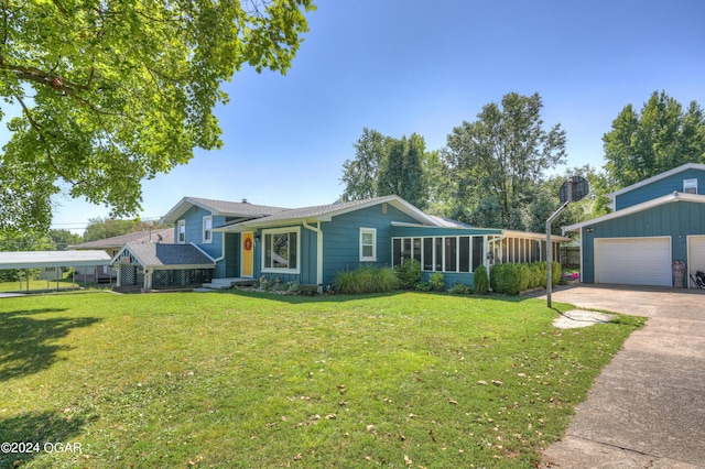 view of front facade with a front yard, a sunroom, and a garage