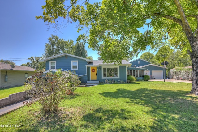 view of front of house featuring a garage and a front yard