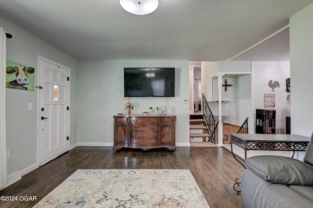 living room with a fireplace and dark hardwood / wood-style flooring