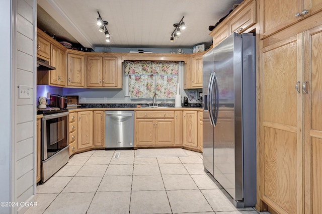 kitchen featuring rail lighting, sink, light tile patterned floors, and appliances with stainless steel finishes