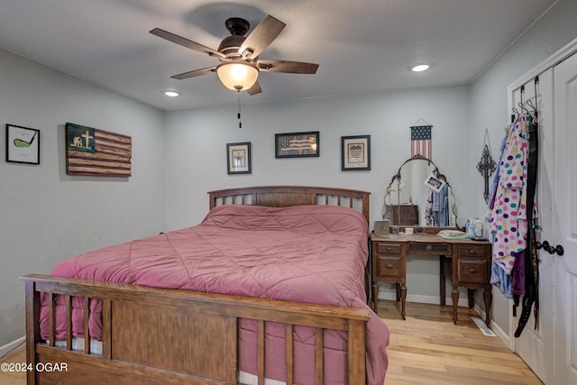 bedroom featuring a closet, ceiling fan, and light hardwood / wood-style floors