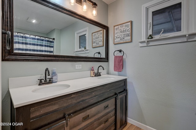 bathroom with wood-type flooring and vanity