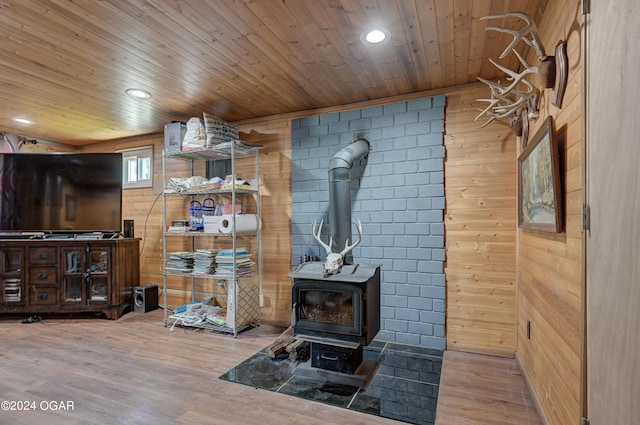 living room with wooden ceiling, wood-type flooring, and a wood stove