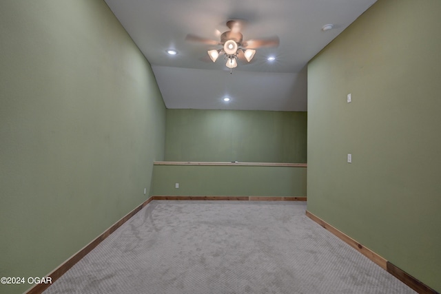 unfurnished room featuring ceiling fan, carpet floors, and vaulted ceiling