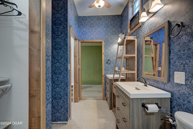 bathroom with vanity, toilet, and ceiling fan