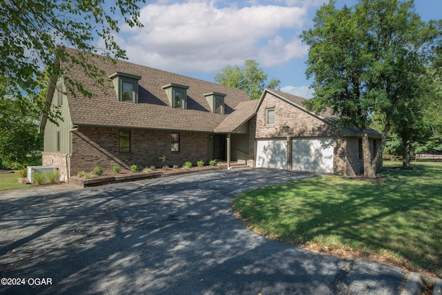 cape cod house with a front lawn and a garage