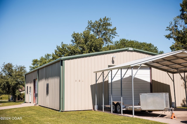 view of outdoor structure featuring a lawn and a carport