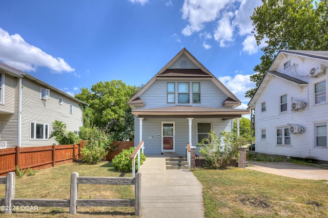 view of front of house featuring covered porch and a front lawn