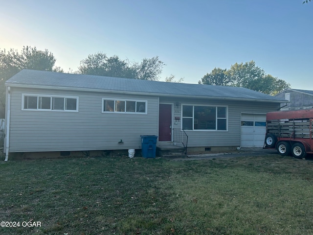 single story home with a front lawn and a garage