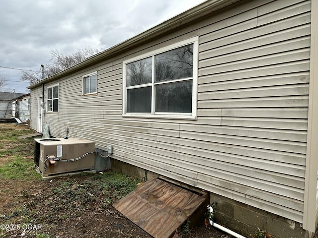 view of side of home featuring central AC