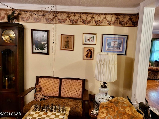 bedroom with wood-type flooring, crown molding, and a textured ceiling