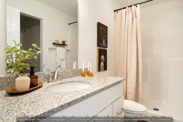 bathroom with walk in shower, toilet, and vanity