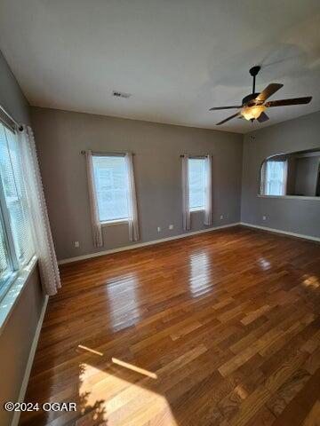 empty room featuring ceiling fan and dark hardwood / wood-style floors