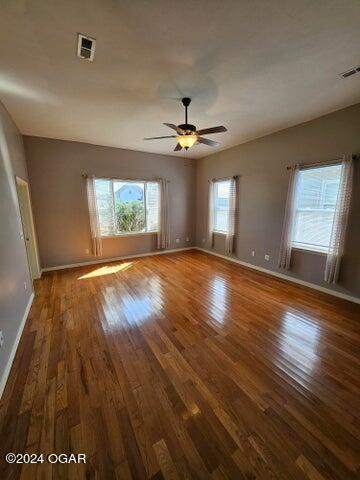 unfurnished room featuring ceiling fan and dark hardwood / wood-style flooring