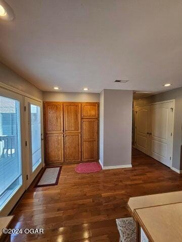 unfurnished living room with dark hardwood / wood-style floors