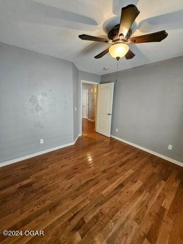 spare room featuring hardwood / wood-style floors and ceiling fan