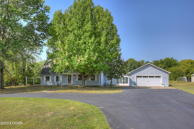 9825 County Rd 215, Webb City, MO 64870 - view of front of home featuring driveway, a front yard, and an attached garage