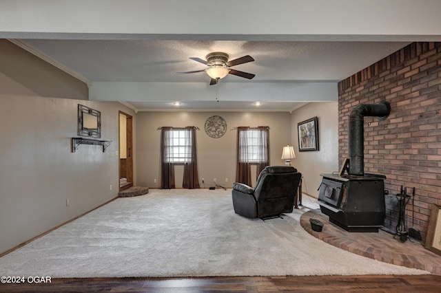 9825 County Rd 215, Webb City, MO 64870 - living room with a wood stove, a ceiling fan, wood finished floors, baseboards, and crown molding