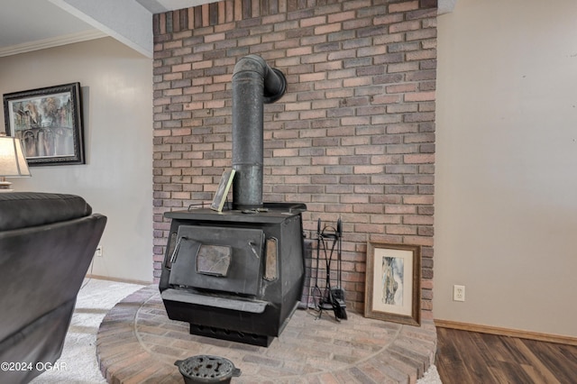 9825 County Rd 215, Webb City, MO 64870 - detailed view of baseboards, crown molding, wood finished floors, and a wood stove