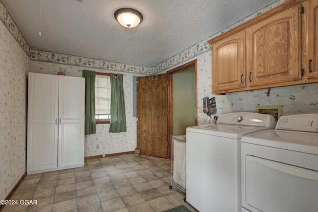 9825 County Rd 215, Webb City, MO 64870 - laundry room featuring wallpapered walls, washer and clothes dryer, cabinet space, baseboards, and a textured ceiling