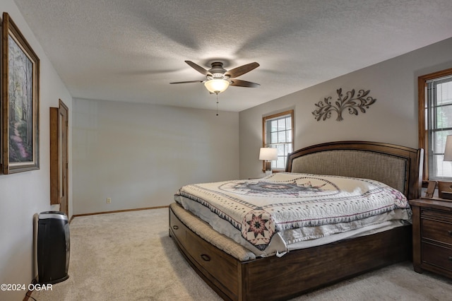 9825 County Rd 215, Webb City, MO 64870 - bedroom with light carpet, heating unit, ceiling fan, baseboards, and a textured ceiling