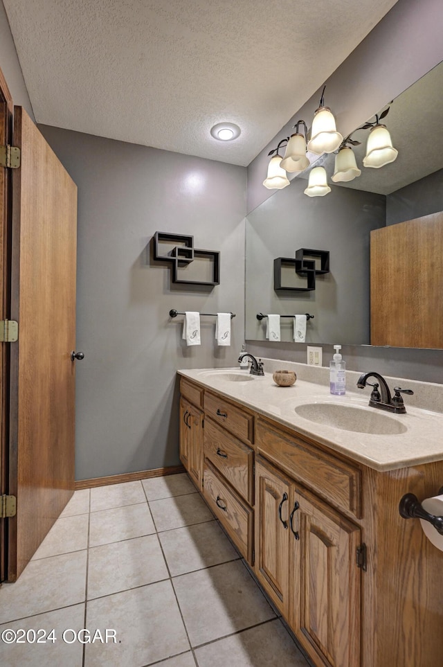 9825 County Rd 215, Webb City, MO 64870 - bathroom with tile patterned flooring, a textured ceiling, double vanity, and baseboards