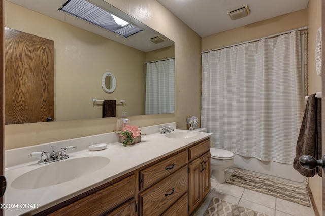 9825 County Rd 215, Webb City, MO 64870 - bathroom with toilet, double vanity, tile patterned floors, and shower / bath combo with shower curtain