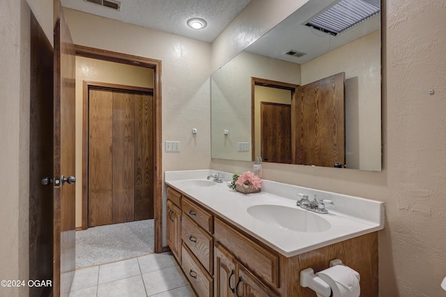 9825 County Rd 215, Webb City, MO 64870 - full bath featuring double vanity, tile patterned floors, a textured wall, and a textured ceiling