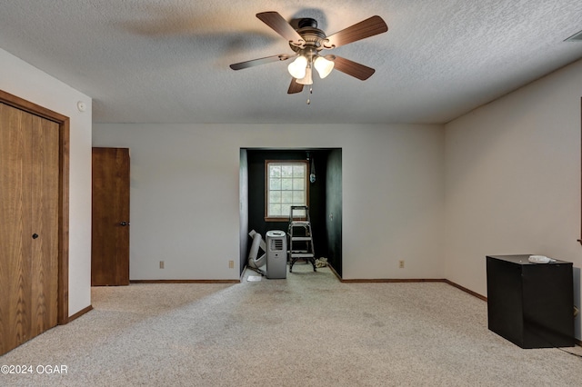 9825 County Rd 215, Webb City, MO 64870 - unfurnished room featuring light colored carpet, a textured ceiling, baseboards, and a ceiling fan