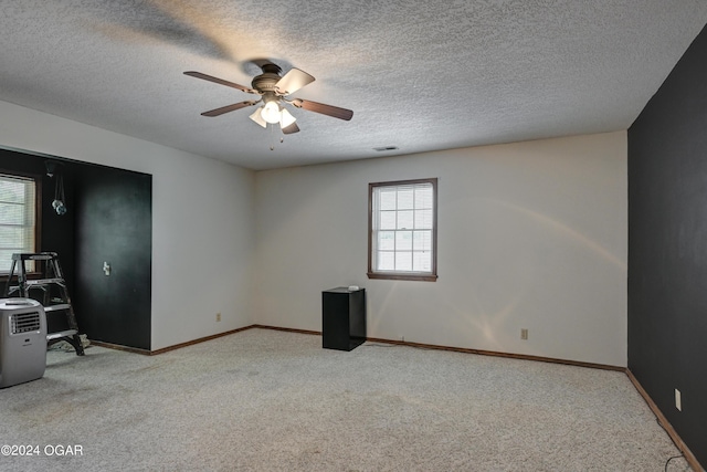 9825 County Rd 215, Webb City, MO 64870 - carpeted spare room with a textured ceiling, a ceiling fan, and baseboards
