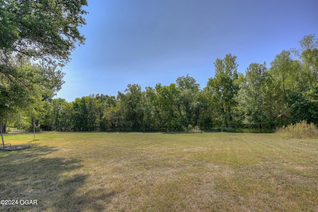 9825 County Rd 215, Webb City, MO 64870 - view of grassy yard with a wooded view